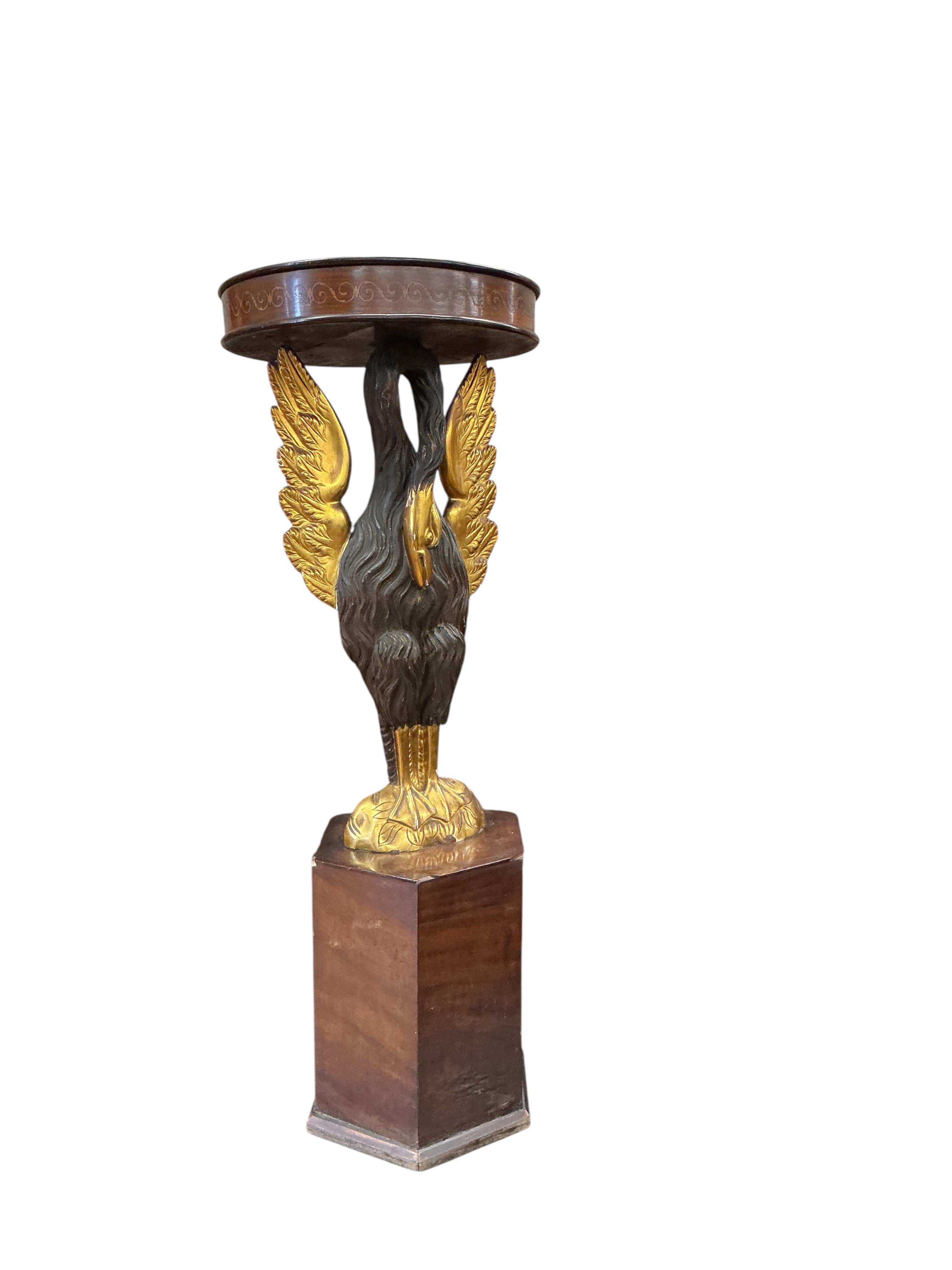 An Empire style carved wood phoenix occasional table on hexagonal plinth, height 99cm